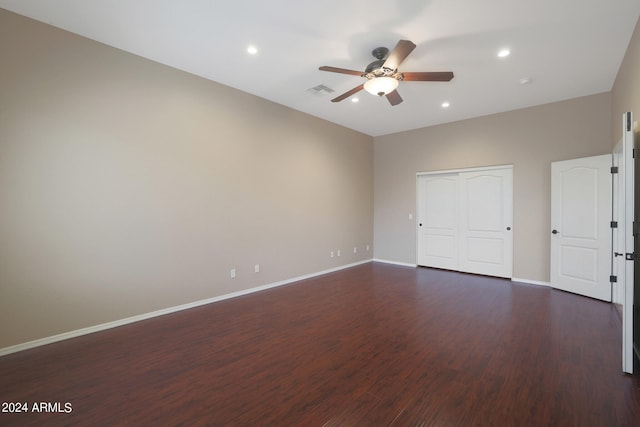 unfurnished bedroom featuring ceiling fan, a closet, and dark hardwood / wood-style floors