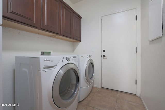 laundry area with cabinets, washer and dryer, and light tile patterned floors