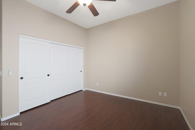 unfurnished bedroom featuring ceiling fan, dark wood-type flooring, and a closet