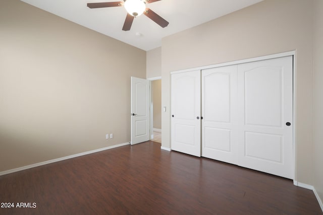 unfurnished bedroom with ceiling fan, a closet, and dark hardwood / wood-style flooring