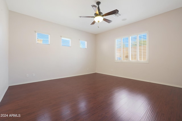 unfurnished room featuring ceiling fan and dark hardwood / wood-style flooring