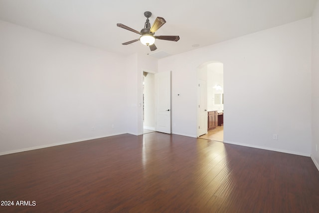 spare room featuring dark hardwood / wood-style flooring and ceiling fan