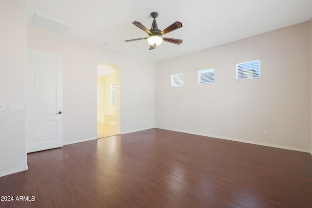 spare room with dark hardwood / wood-style floors and ceiling fan