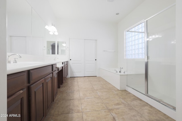 bathroom with tile patterned floors, independent shower and bath, and vanity