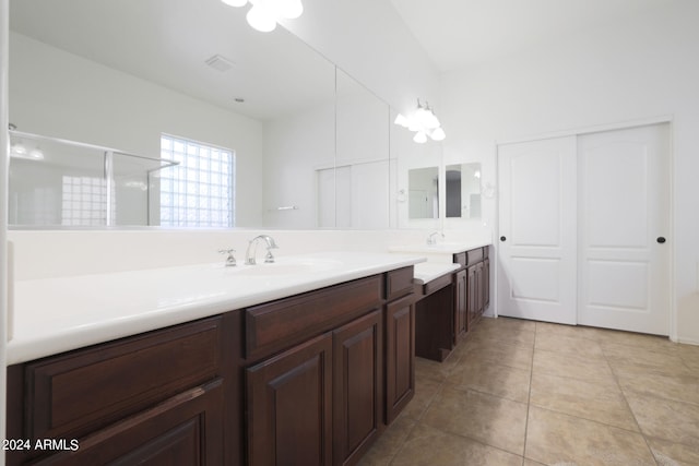 bathroom with vanity, a shower with door, and tile patterned floors