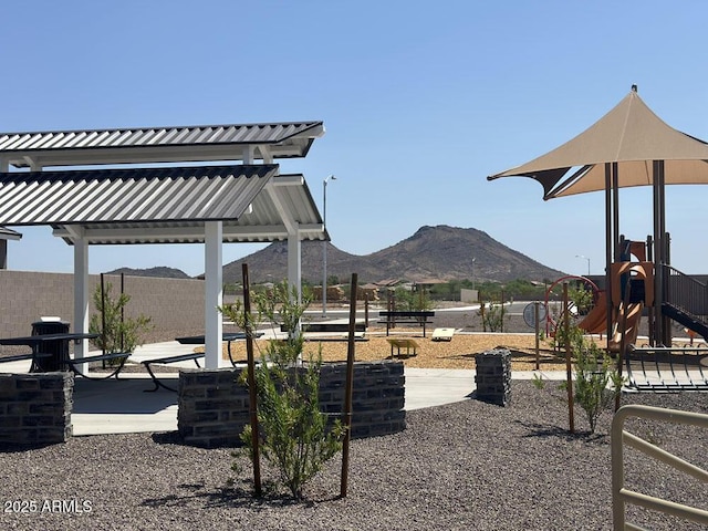 view of jungle gym featuring a mountain view