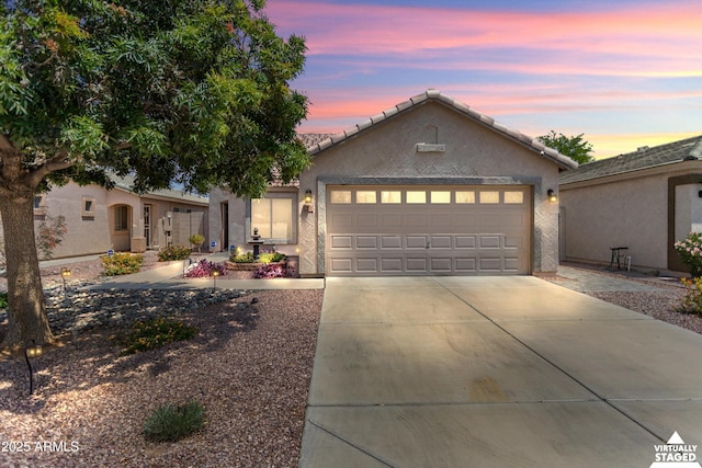2717 N 107th Dr, Avondale, AZ 85392 - single story home featuring concrete driveway, an attached garage, stucco siding, and a tiled roof