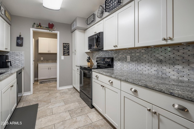 kitchen with light stone counters, decorative backsplash, white cabinets, black appliances, and baseboards