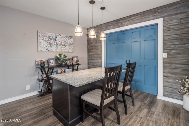 dining area featuring dark wood-style floors and baseboards