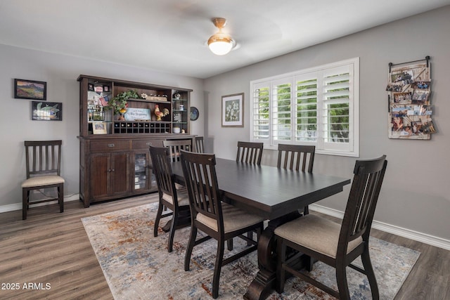 dining area featuring wood finished floors and baseboards