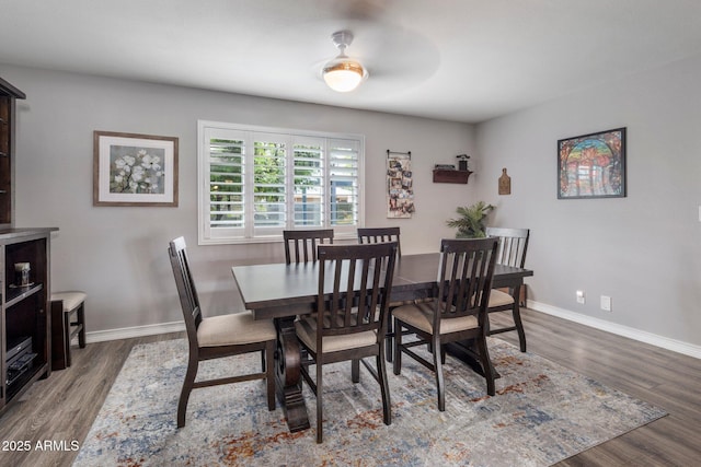 dining space featuring baseboards and wood finished floors