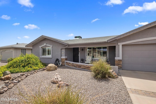 ranch-style house featuring a garage, stone siding, roof with shingles, and stucco siding