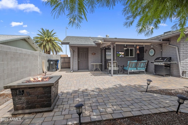 view of patio / terrace featuring an outdoor fire pit, ceiling fan, grilling area, and fence private yard