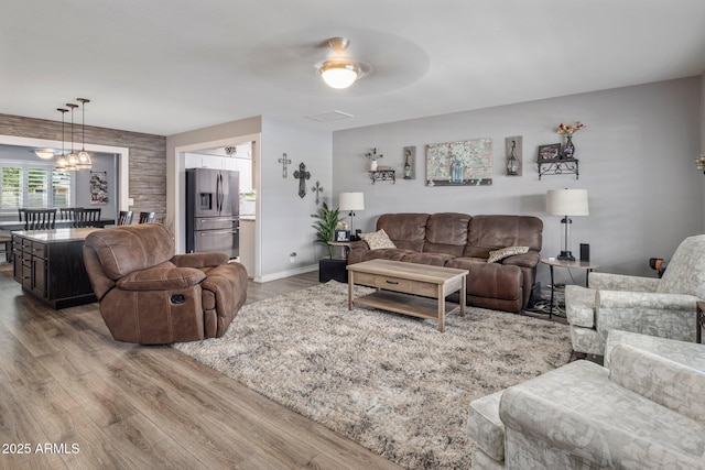 living area with wood finished floors and baseboards