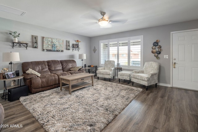 living room with dark wood-style flooring, ceiling fan, and baseboards