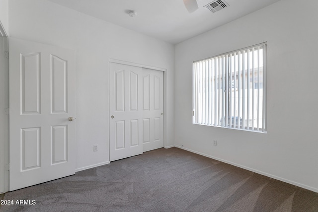 unfurnished bedroom featuring a closet, ceiling fan, and carpet