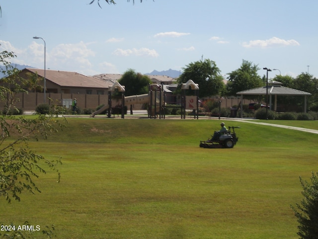 view of community with a gazebo, a lawn, and a playground