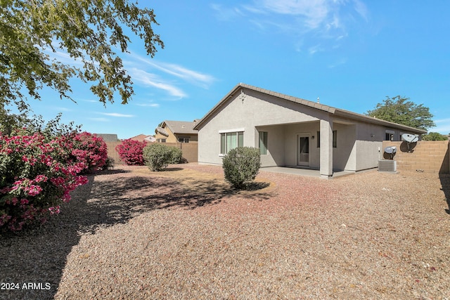 rear view of property featuring cooling unit and a patio area