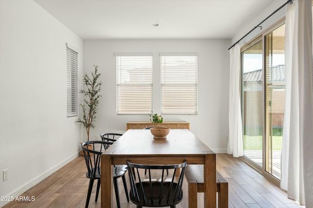 dining space with light hardwood / wood-style flooring