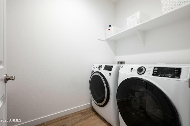 laundry room featuring independent washer and dryer and light wood-type flooring