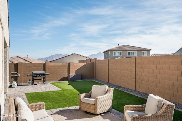 view of yard featuring a mountain view and a patio