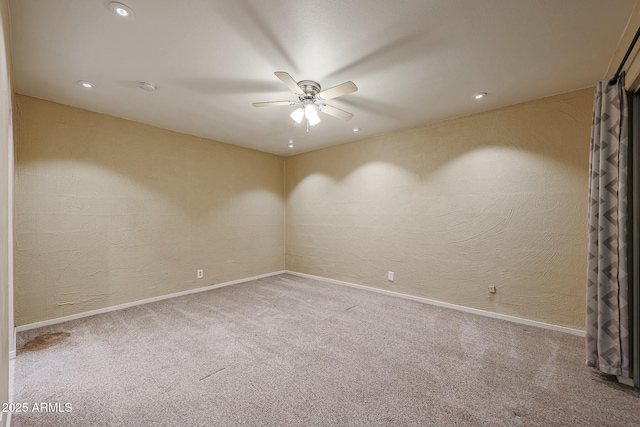 carpeted spare room with ceiling fan