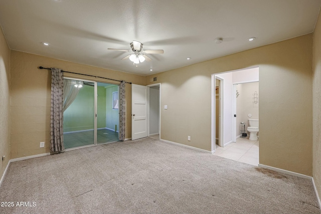 carpeted spare room featuring ceiling fan