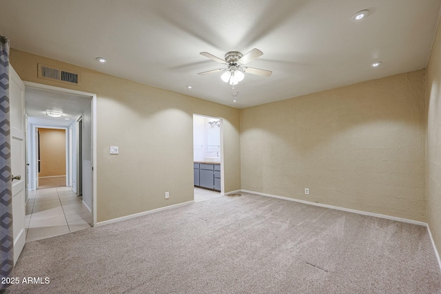 unfurnished room with ceiling fan and light colored carpet