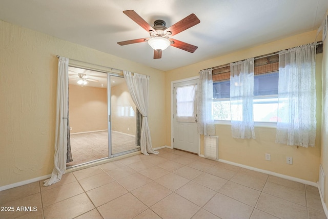 unfurnished room featuring ceiling fan and light tile patterned floors