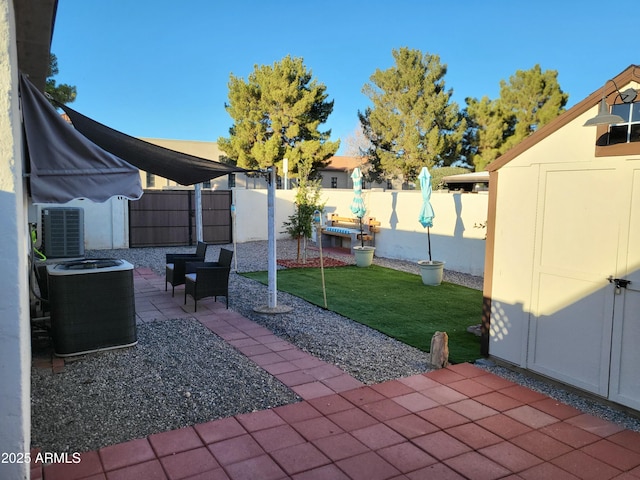 view of patio with a storage shed and central air condition unit