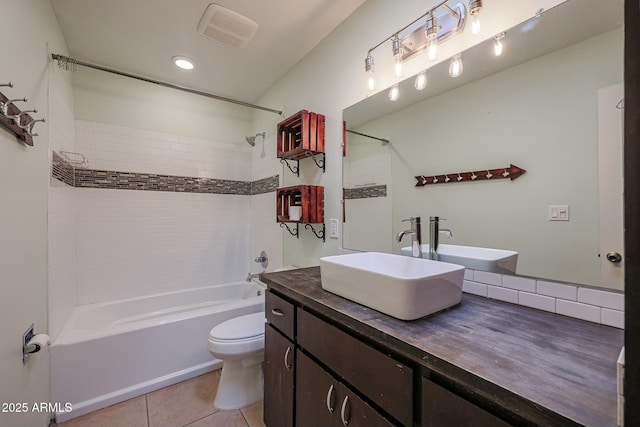 full bathroom with tile patterned floors, tiled shower / bath combo, toilet, and vanity