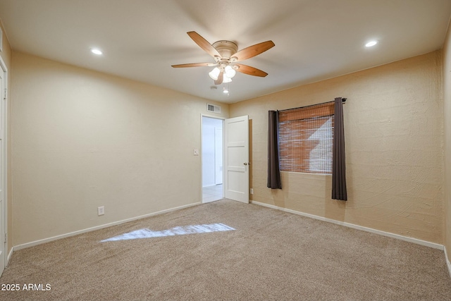 unfurnished room featuring light carpet and ceiling fan