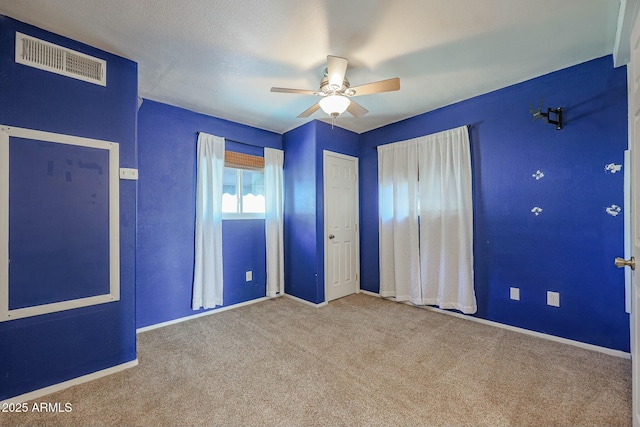 unfurnished bedroom featuring ceiling fan and light carpet