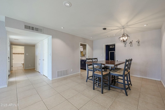 tiled dining room featuring a notable chandelier