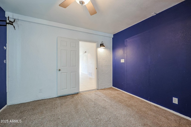 unfurnished room featuring carpet flooring and ceiling fan