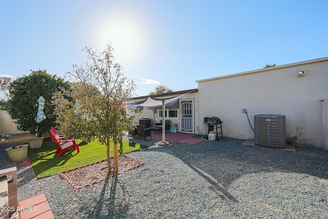 view of yard featuring cooling unit and a patio