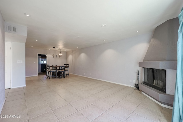 tiled living room with a multi sided fireplace