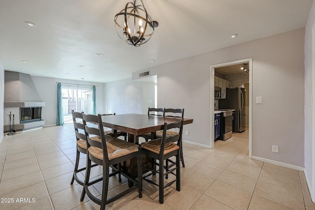 tiled dining area featuring an inviting chandelier