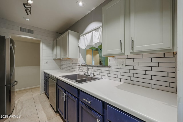 kitchen featuring blue cabinetry, white cabinetry, sink, stainless steel appliances, and light tile patterned floors