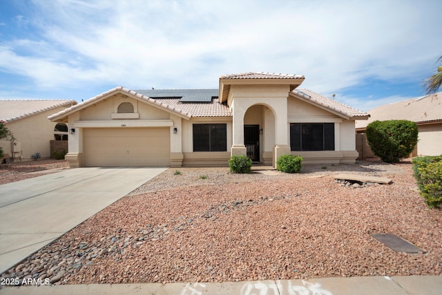 6366 W Saint John Ave, Glendale, AZ 85308 - mediterranean / spanish house with a tile roof, stucco siding, an attached garage, driveway, and solar panels