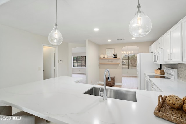 6366 W Saint John Ave, Glendale, AZ 85308 - kitchen with white appliances, arched walkways, a sink, white cabinetry, and pendant lighting