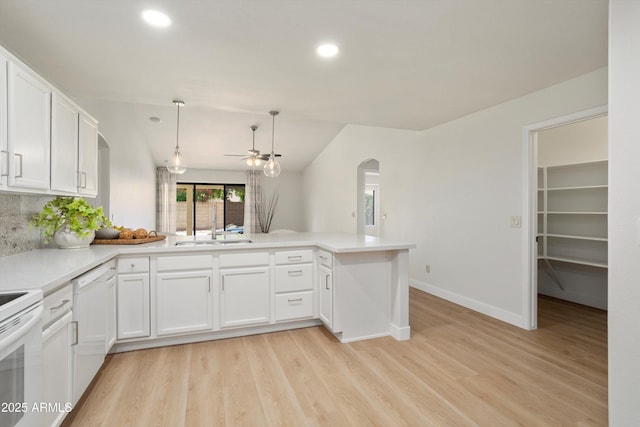 6366 W Saint John Ave, Glendale, AZ 85308 - kitchen featuring arched walkways, a ceiling fan, light wood finished floors, white cabinetry, and recessed lighting