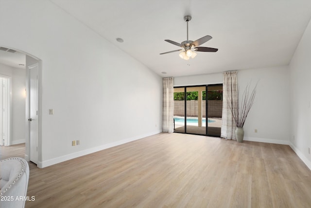 6366 W Saint John Ave, Glendale, AZ 85308 - empty room featuring ceiling fan, arched walkways, light wood-style floors, lofted ceiling, and baseboards