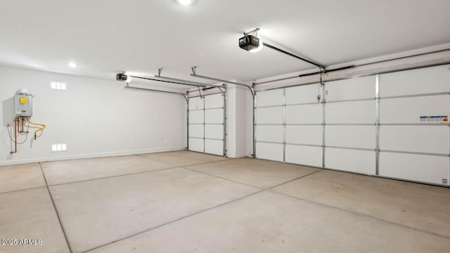 2640 W Stanton Ave, Apache Junction, AZ 85120 - garage with a garage door opener and baseboards