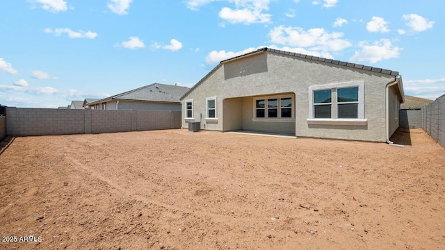 2640 W Stanton Ave, Apache Junction, AZ 85120 - back of property featuring a fenced backyard, stucco siding, and central AC
