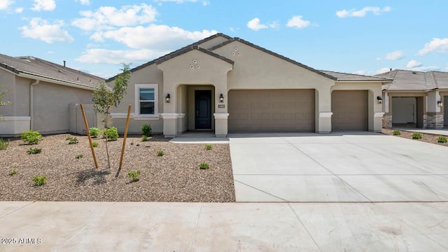 2640 W Stanton Ave, Apache Junction, AZ 85120 - view of front facade featuring a garage, stucco siding, driveway, and a tile roof