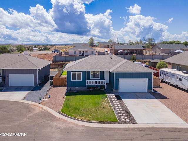 1028 W Ione Ln, Taylor, AZ 85939 - single story home featuring fence, a garage, a front yard, a residential view, and driveway
