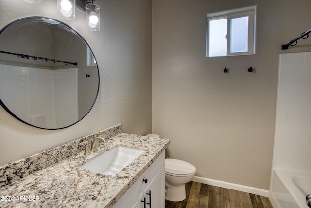 full bathroom with hardwood / wood-style floors, vanity, toilet, and shower / bath combination