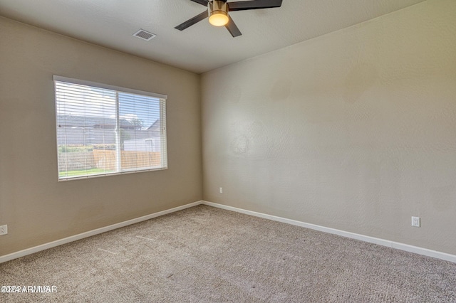 unfurnished room with ceiling fan and light colored carpet