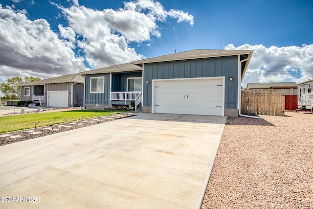 1028 W Ione Ln, Taylor, AZ 85939 - single story home with an attached garage, fence, board and batten siding, and concrete driveway